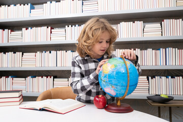 School and students in classroom. Education kids. Clever Child pupil student in the school class. Studying and learning concept. School boy in library near school supplies. Kid learn geography with