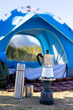 © Wavebreak Media - Camping with blue tent, portable stove, and coffee maker in mountain hike setup, copy space