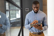 © Wavebreak Media - African American businessman using tablet, focusing on work in modern office