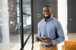 © Wavebreak Media - African American male professional holding tablet, smiling in modern office setting