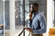 © Wavebreak Media - African American businessman holding tablet, analyzing data on glass board in office