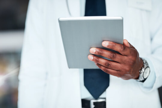 Doctor, man and tablet in hands for healthcare, planning and medical website to research diagnosis. Male person, medicine and online for consulting, telehealth and app for clinic patient system