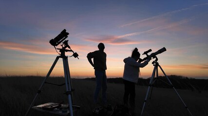 Wall Mural - people enjoying watching and stargazing with astronomy telescopes outdoors in nature, observing plan