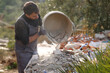 © Antonioguillem - Construction worker emptying debris from carrycot