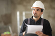 © Antonioguillem - Disappointed construction worker checking work taking notes