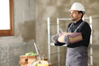 © Antonioguillem - Construction worker carrying cement bag