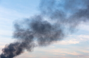 Black smoke from a fire against the sky