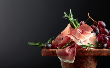 Wall Mural - Prosciutto with grapes and rosemary.