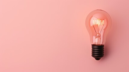 A close-up of a black lightbulb with a soft, warm glow, isolated on a plain background. The minimalist composition offers plenty of copy space for adding text or graphics.