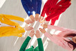 © Studio Romantic - Hands together, group of friends united joined as whole, business harmony, agreement or concord. People in circle wearing vibrant vivid formal color suit, working together, life, team building support