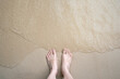 © maemanee - Woman feet standing on sand beach with her bare feet at the sea. Naked feet at the beach with wave on vacation. Barefeet nature background concept, copy space.