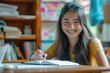 © Web - High School Reading. Smiling Asian Teenage Student Doing Homework at Home