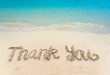 © maemanee - Thank you lettering on the beach with wave and clear blue sea. Thank you card with message written in golden sand on clean beach background. Gratitude concept. Copy space.
