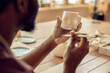 © zinkevych - Male sculptor brushing the clay mug and looking involved