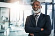 © peopleimages.com - Manager, portrait and mature black man with arms crossed for corporate career, business or leadership. Face, professional or smile of confident entrepreneur, ceo or sales advisor in office in Nigeria