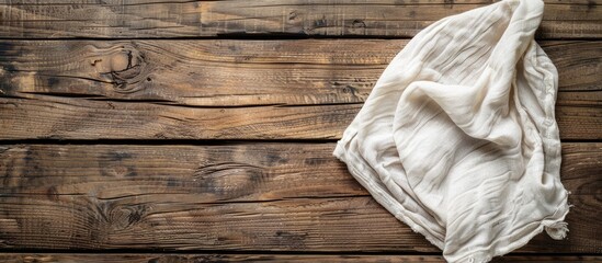 Aufkleber - A kitchen towel or napkin is placed on a rustic wooden table in an overhead view, offering copy space in the image.