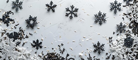 Wall Mural - Top view of Let It Snow quote and snowflakes crafted from dried tea leaves on a white surface with room for your message in the copy space image.