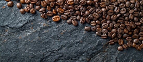 Wall Mural - Flatlay view of coffee beans arranged on a black stone background with copy space image.