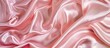 © HN Works - Luxurious baby pink satin silk fabric with a smooth, elegant, wavy texture for an abstract background design, providing copy space image.