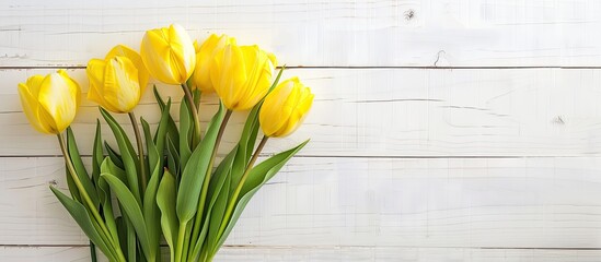 Fototapete - Yellow tulip bouquet on white wood backdrop with copy space image. Perfect for various occasions like Valentine's or Mother's Day. Top view presentation.