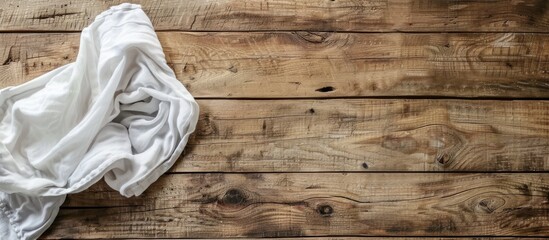 Aufkleber - A kitchen towel or napkin is placed on a rustic wooden table in an overhead view, offering copy space in the image.