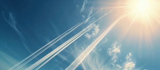 Aufkleber - Streaks left by airplanes in the clear sky with a bright sun and abundant copy space image.