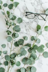 Sticker - A pair of glasses sits on a table next to a bunch of green leaves