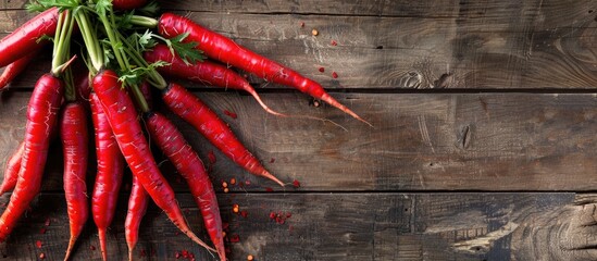 Wall Mural - Top view of red carrots on an aged wooden surface with room for text or other elements in the image. Copy space image. Place for adding text and design