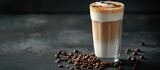 Latte macchiato and geyser coffee maker displayed with a glass of latte macchiato, scattered coffee beans on a dark background, with ample copy space image.