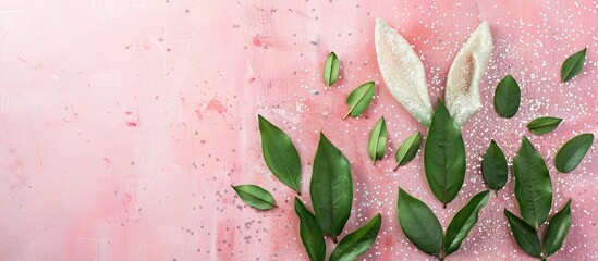 Leinwandbilder - Easter concept with bunny ears made of green leaves on a glittery pink and white background in a flat lay style with copy space image opportunity.