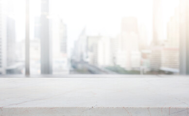 Wall Mural - Modern marble table top on blur abstract window glass with city town background.