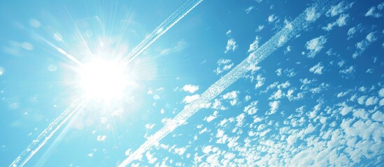 Aufkleber - Streaks left by airplanes in the clear sky with a bright sun and abundant copy space image.
