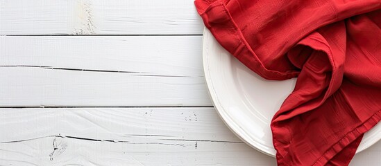 Poster - Top-down view of a red kitchen napkin on a table. The cloth is folded for a mockup with a white area for text or an image, in a minimalist flat lay style. Copy space image