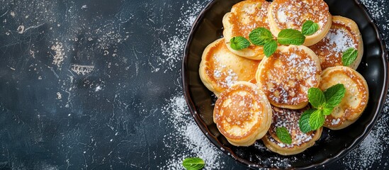 Mint-topped poffertjes on special grooved pan, showcasing healthy food concept with copy space image.