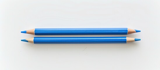 Fototapete - A top-down view of two blue pencils on a white background, with space for adding text or images, emphasizing an educational theme. Copy space image. Place for adding text and design