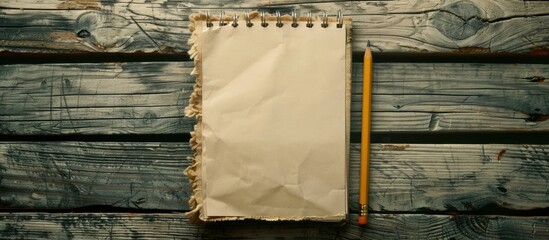 Fototapete - Image of a notepad and pencil on a wooden background, suitable for educational or business purposes, emphasizing the space for text or objects in photography. Copy space image