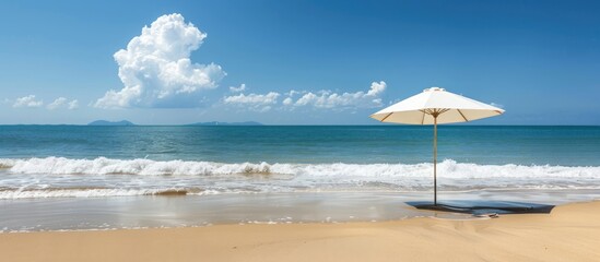 Aufkleber - Beach scene with umbrella on sandy shore, offering a serene view with ample copy space image.