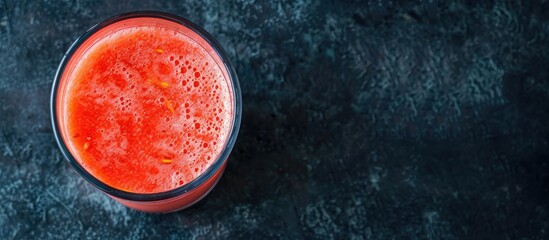Aufkleber - Top view of a glass of watermelon smoothie on a dark table with ample copy space image.