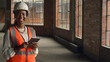 © Meeko Media - Confident Female Engineer in Safety Gear Holding Tablet in a Construction Site