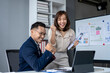 © Wasana - The woman is holding a clipboard and the man is holding a pen
