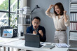 © Wasana - A man and a woman are celebrating in front of a computer monitor
