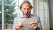 © Mystery - Frightened and surprised man reading newspaper
