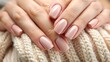 © Mystery - Closeup to woman hands with elegant neutral pink color manicure