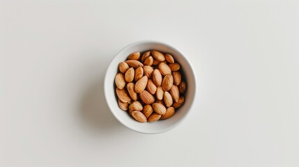 Wall Mural - Almond roasted in a small white bowl on a white background from a top down perspective