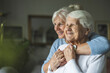 © pikselstock - Happy senior woman with her adult daughter at home