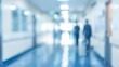 © Digital Dreamscapes - A modern healthcare environment is shown through a blurred hospital corridor with bright lights, indicating busyness