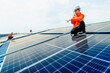 © ultramansk - engineer man inspects construction of solar cell panel or photovoltaic cell by electronic device. Industrial Renewable energy of green power. factory worker working on tower roof.