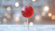 © SashaMagic - Red lollipop with sugar-coated, blurred bokeh lights background.