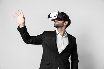 Smart business man with suit holding something while VR goggle to connect metaverse. Professional project manager looking at hologram by using visual reality headset. Technology innovation. Deviation.