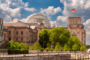 Wall Mural - Glass dome and waving German national flags on the Reichstag building. Berlin.